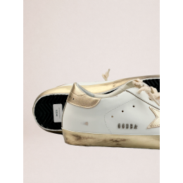 Golden Goose Super Star with gold sparkle foxing and metal stud lettering